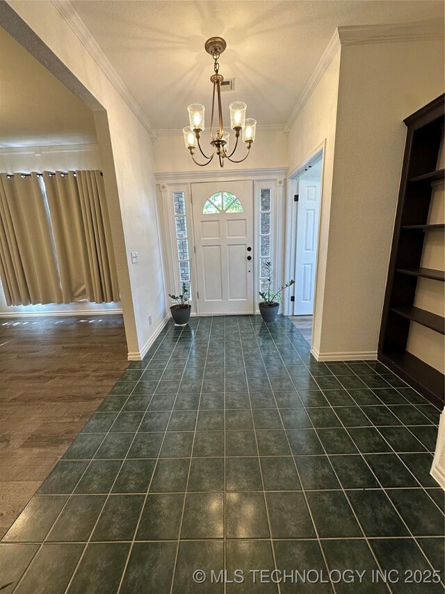 7604 N 127th E Ave, Owasso, OK 74055 - foyer featuring a chandelier, ornamental molding, baseboards, and dark tile patterned flooring