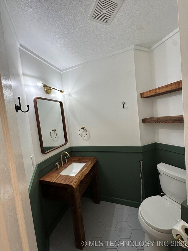 7604 N 127th E Ave, Owasso, OK 74055 - bathroom featuring a textured ceiling, toilet, tile patterned floors, and vanity