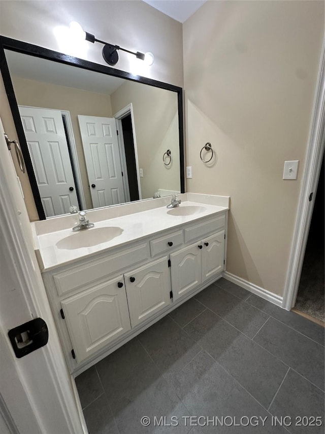 7604 N 127th E Ave, Owasso, OK 74055 - bathroom featuring tile patterned flooring, double vanity, and baseboards