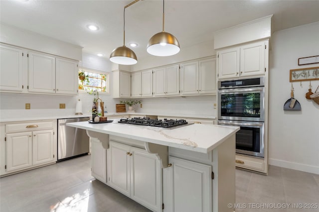 8721 S 65th E Pl, Tulsa, OK 74133 - kitchen with appliances with stainless steel finishes, light tile patterned flooring, recessed lighting, a kitchen island, and white cabinets