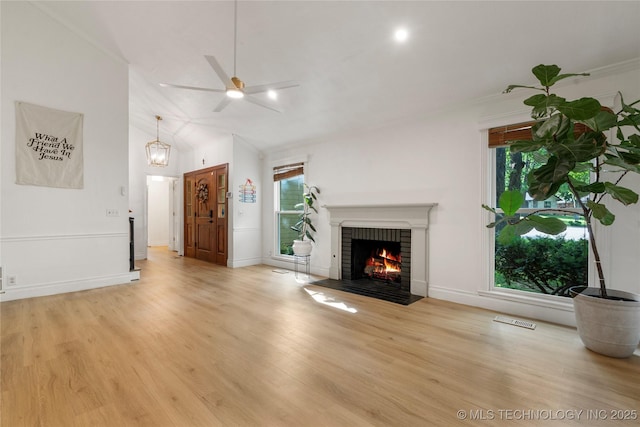 8721 S 65th E Pl, Tulsa, OK 74133 - unfurnished living room with a fireplace, light wood finished floors, a ceiling fan, lofted ceiling, and baseboards