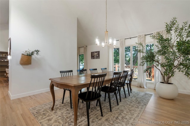 8721 S 65th E Pl, Tulsa, OK 74133 - dining room featuring baseboards, a chandelier, light wood-style flooring, and high vaulted ceiling