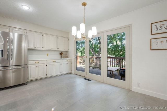 8721 S 65th E Pl, Tulsa, OK 74133 - unfurnished dining area with a chandelier and baseboards
