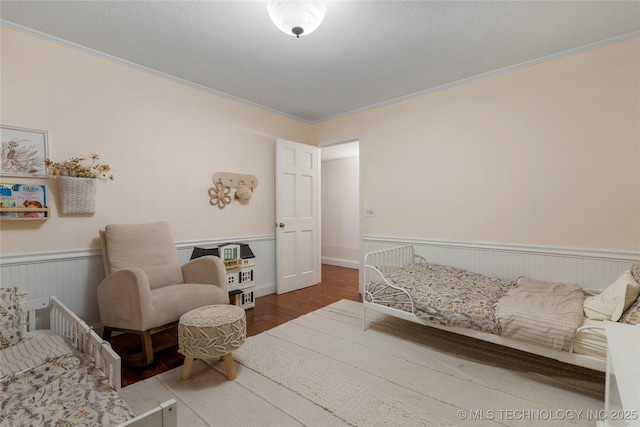 8721 S 65th E Pl, Tulsa, OK 74133 - bedroom featuring wood finished floors, crown molding, and a wainscoted wall