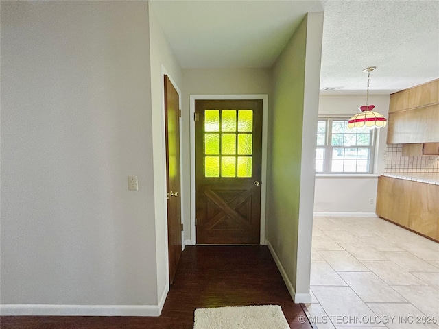 502 W Elm St, Henryetta, OK 74437 - doorway to outside featuring baseboards