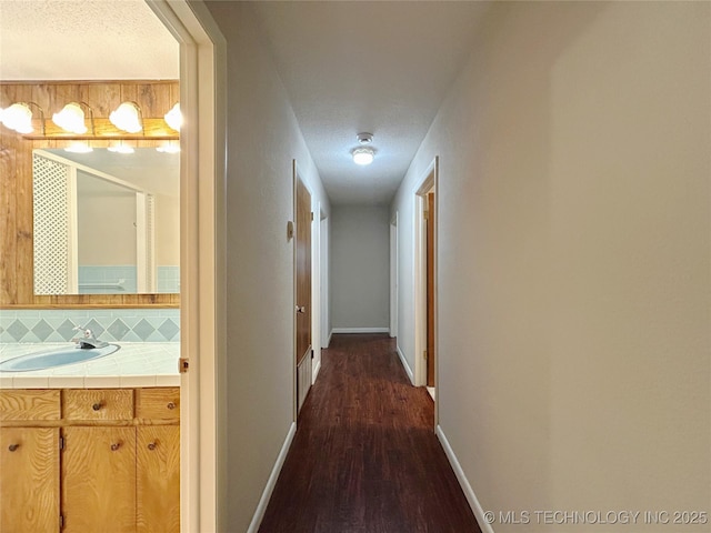 502 W Elm St, Henryetta, OK 74437 - hallway featuring dark wood-style floors and a textured ceiling