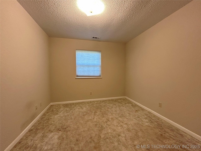 502 W Elm St, Henryetta, OK 74437 - carpeted spare room with a textured ceiling and baseboards