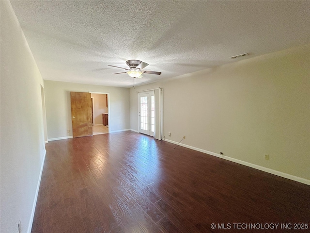 502 W Elm St, Henryetta, OK 74437 - unfurnished room with a ceiling fan, dark wood-type flooring, and a textured ceiling