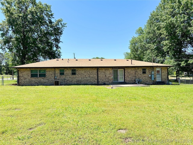 502 W Elm St, Henryetta, OK 74437 - back of house featuring a patio and brick siding