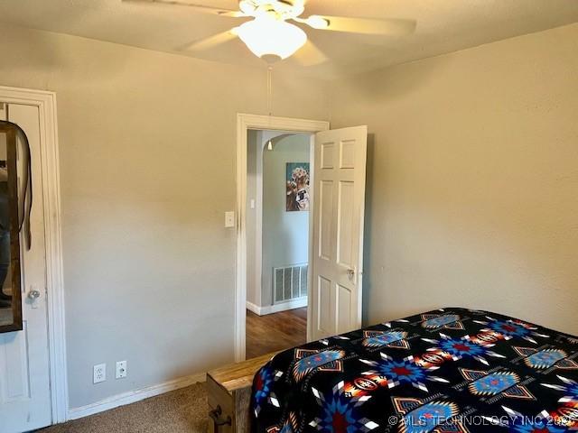 2201 Baugh St, Muskogee, OK 74403 - carpeted bedroom with ceiling fan and baseboards