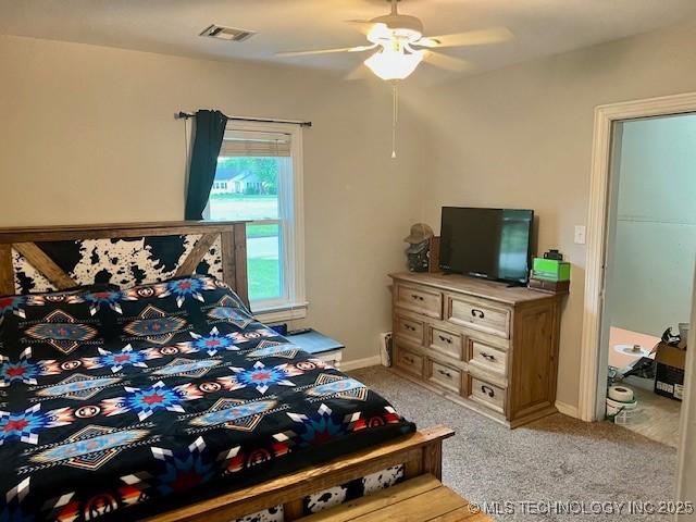 2201 Baugh St, Muskogee, OK 74403 - bedroom with light colored carpet, ceiling fan, and baseboards