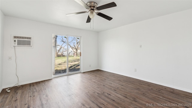 416 S Cedar St, Owasso, OK 74055 - spare room with a wall mounted AC, wood finished floors, baseboards, and ceiling fan