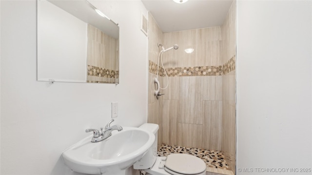 416 S Cedar St, Owasso, OK 74055 - bathroom featuring a sink, a stall shower, and toilet