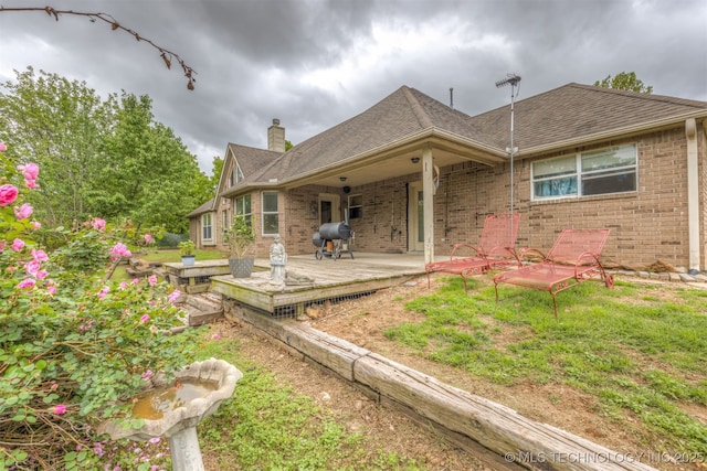 4157 New Prue Rd, Sand Springs, OK 74063 - rear view of property with a chimney, brick siding, a shingled roof, and a deck