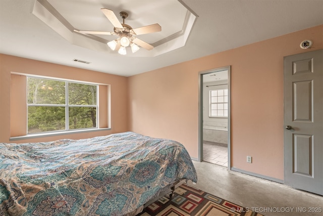 4157 New Prue Rd, Sand Springs, OK 74063 - bedroom featuring multiple windows, a tray ceiling, a ceiling fan, and ensuite bathroom