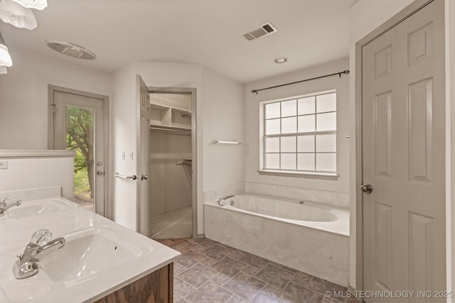 4157 New Prue Rd, Sand Springs, OK 74063 - full bath featuring a closet, stone finish flooring, a garden tub, double vanity, and recessed lighting
