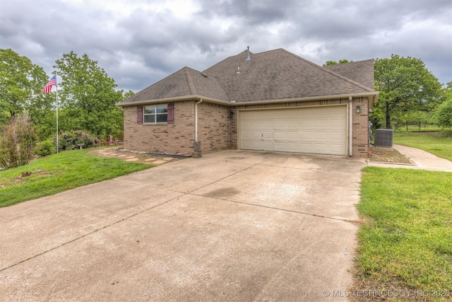 4157 New Prue Rd, Sand Springs, OK 74063 - view of front of home featuring brick siding, roof with shingles, driveway, a front lawn, and an attached garage