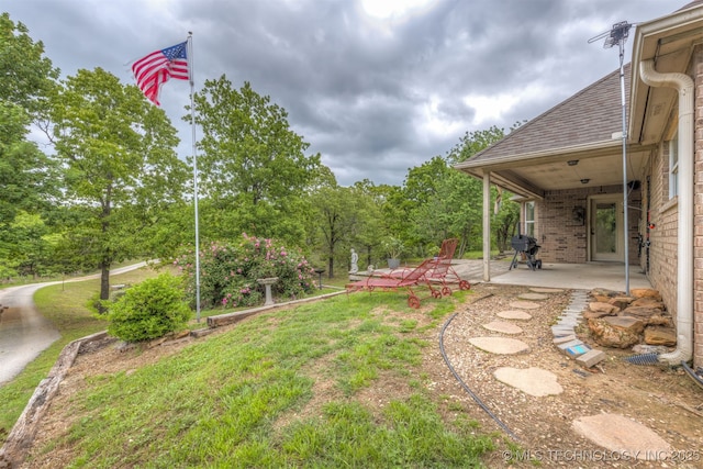 4157 New Prue Rd, Sand Springs, OK 74063 - view of green lawn with a patio and view of wooded area