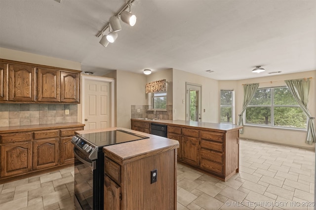4157 New Prue Rd, Sand Springs, OK 74063 - kitchen with stainless steel electric range, a kitchen island, a peninsula, and backsplash