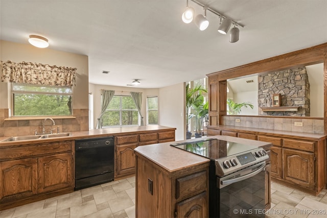 4157 New Prue Rd, Sand Springs, OK 74063 - kitchen featuring stainless steel electric range oven, dishwasher, a sink, brown cabinetry, and a center island