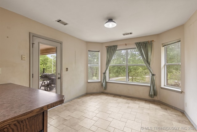 4157 New Prue Rd, Sand Springs, OK 74063 - unfurnished dining area featuring stone finish flooring, healthy amount of natural light, and baseboards