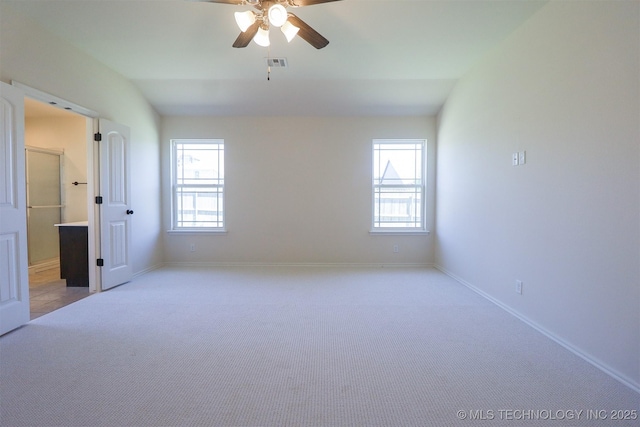 14602 E 114th St N, Owasso, OK 74055 - unfurnished bedroom featuring light colored carpet, baseboards, ceiling fan, lofted ceiling, and ensuite bathroom