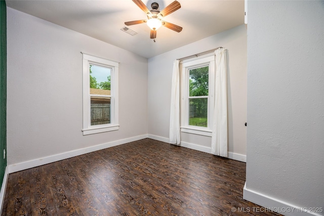 1020 N 3rd, Durant, OK 74701 - spare room featuring plenty of natural light, ceiling fan, wood finished floors, and baseboards