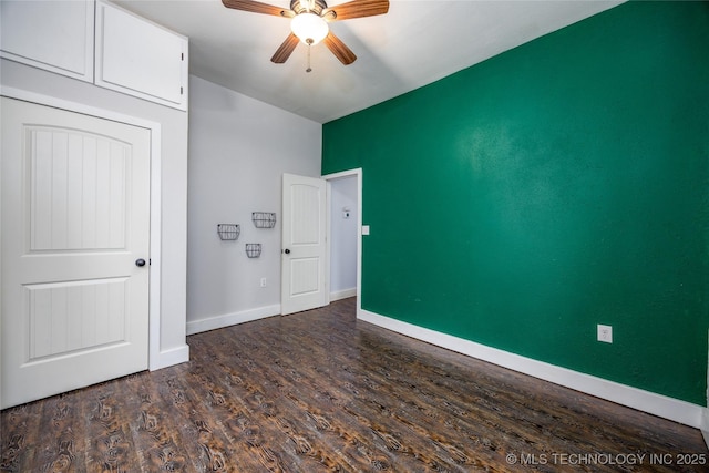 1020 N 3rd, Durant, OK 74701 - unfurnished bedroom with dark wood-style flooring, baseboards, ceiling fan, and lofted ceiling