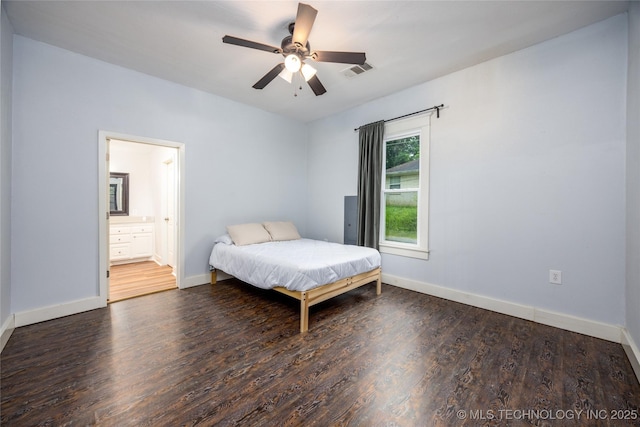 1020 N 3rd, Durant, OK 74701 - bedroom with wood finished floors, baseboards, connected bathroom, and ceiling fan