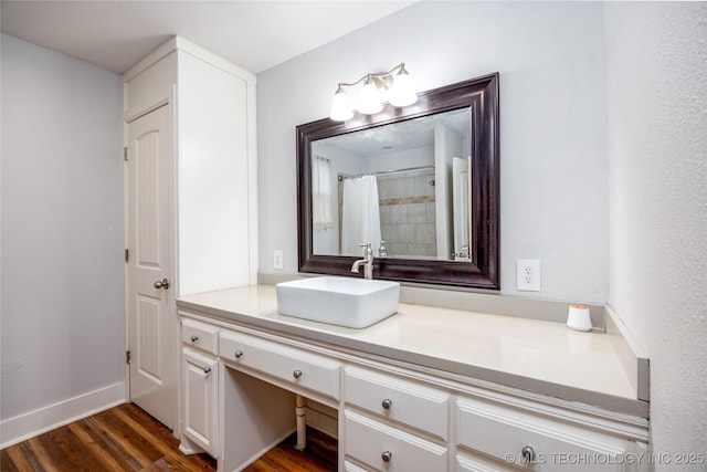 1020 N 3rd, Durant, OK 74701 - bathroom featuring wood finished floors, vanity, baseboards, and a shower with shower curtain