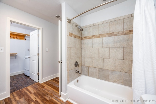 1020 N 3rd, Durant, OK 74701 - bathroom with shower / bath combo with shower curtain, wood finished floors, and baseboards