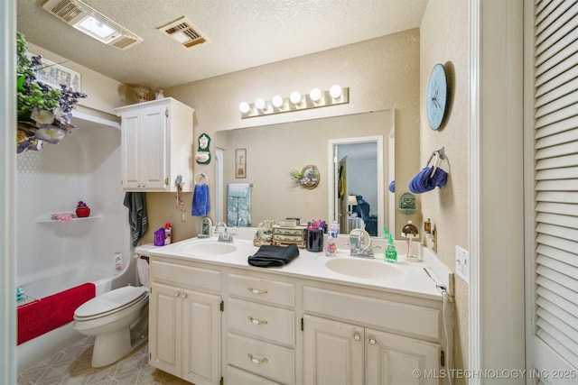32410 W 301st St S, Bristow, OK 74010 - full bathroom featuring double vanity, toilet, a textured ceiling, and tile patterned flooring