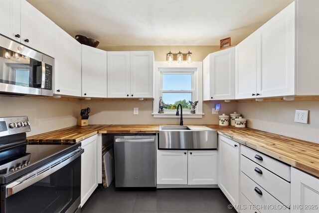 780452 S 3530, Cushing, OK 74023 - kitchen with wooden counters, stainless steel appliances, a sink, and white cabinetry