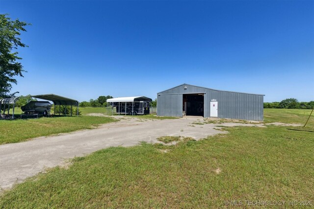 780452 S 3530, Cushing, OK 74023 - view of pole building featuring a yard, a detached carport, and driveway