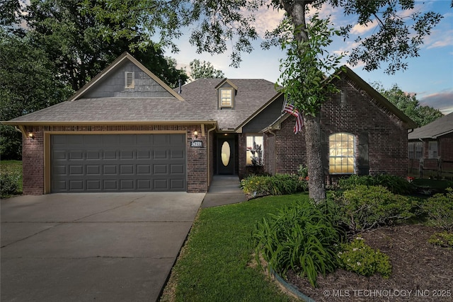 26233 E 114th Pl, Coweta, OK 74429 - view of front of home featuring driveway, brick siding, an attached garage, and a shingled roof