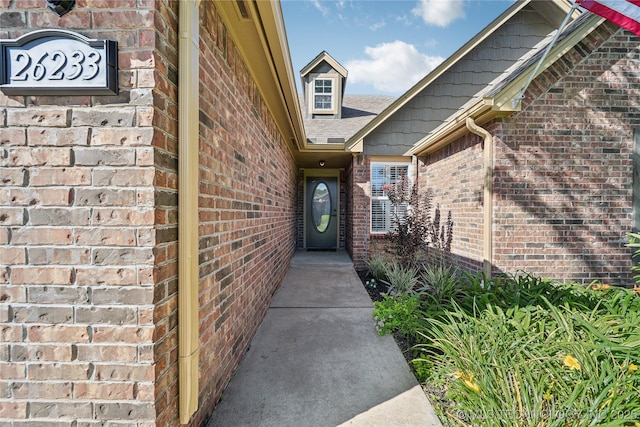 26233 E 114th Pl, Coweta, OK 74429 - doorway to property featuring brick siding and roof with shingles