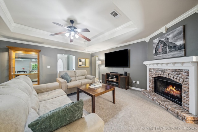 26233 E 114th Pl, Coweta, OK 74429 - living room featuring a raised ceiling, carpet flooring, a ceiling fan, crown molding, and a brick fireplace