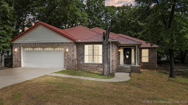 370463 E 5750th Rd, Terlton, OK 74081 - ranch-style home featuring concrete driveway, an attached garage, brick siding, a yard, and metal roof