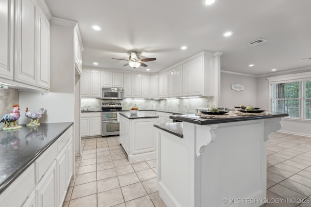 370463 E 5750th Rd, Terlton, OK 74081 - kitchen featuring stainless steel appliances, dark countertops, a peninsula, light tile patterned floors, and recessed lighting