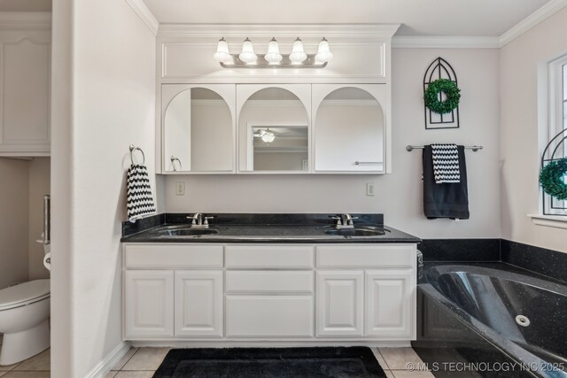 370463 E 5750th Rd, Terlton, OK 74081 - bathroom featuring double vanity, toilet, a whirlpool tub, tile patterned floors, and ornamental molding