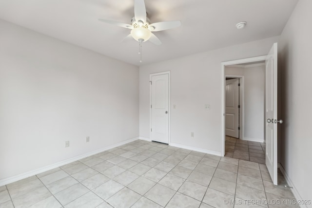 370463 E 5750th Rd, Terlton, OK 74081 - spare room featuring ceiling fan, light tile patterned floors, a smoke detector, and baseboards