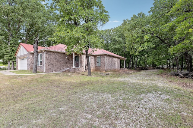 370463 E 5750th Rd, Terlton, OK 74081 - view of side of home with brick siding, an attached garage, and a yard