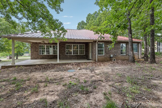 370463 E 5750th Rd, Terlton, OK 74081 - rear view of house featuring ceiling fan, a patio area, brick siding, and metal roof