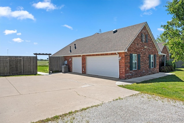 28744 N 3964th Rd, Ochelata, OK 74051 - view of home's exterior featuring a shingled roof, brick siding, driveway, cooling unit, and an attached garage