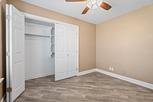 28744 N 3964th Rd, Ochelata, OK 74051 - unfurnished bedroom featuring wood finished floors, a closet, baseboards, and ceiling fan