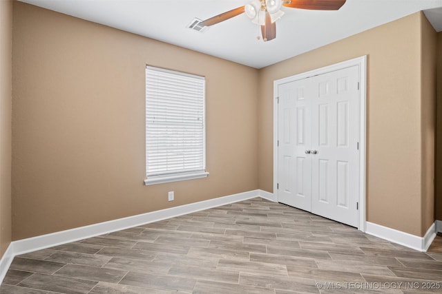 28744 N 3964th Rd, Ochelata, OK 74051 - unfurnished bedroom featuring wood finished floors, a closet, baseboards, and a ceiling fan