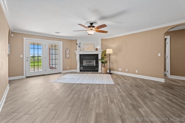 28744 N 3964th Rd, Ochelata, OK 74051 - unfurnished living room with arched walkways, a ceiling fan, baseboards, wood finished floors, and crown molding