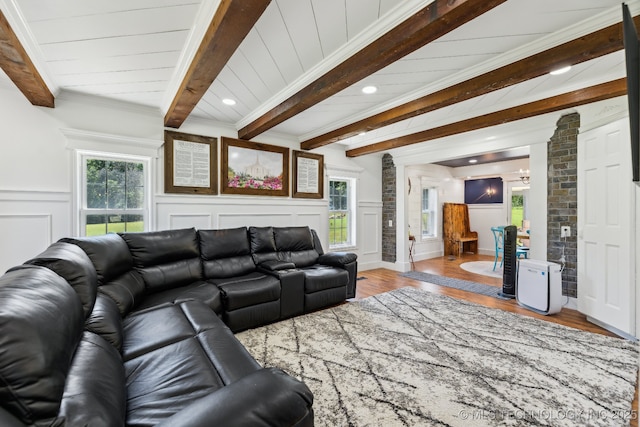 2982 S 294th E Ave, Broken Arrow, OK 74014 - living area with wood finished floors, beam ceiling, plenty of natural light, a decorative wall, and decorative columns