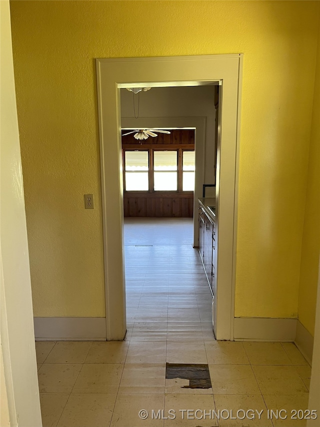 701 NW 3rd St, Stigler, OK 74462 - hallway featuring baseboards and light tile patterned floors