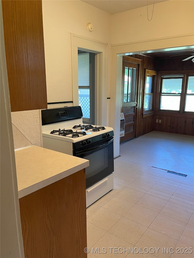 701 NW 3rd St, Stigler, OK 74462 - kitchen featuring range with gas stovetop and light countertops